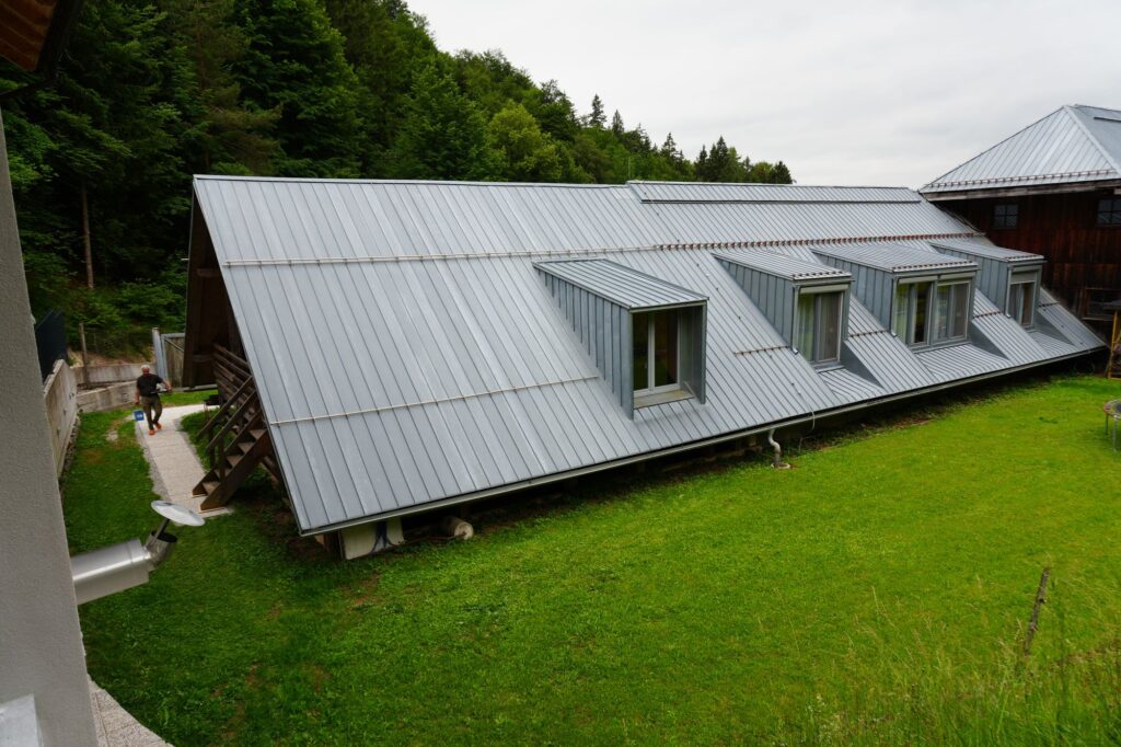 Farmhouse building above a meadow at Forest Farmstay