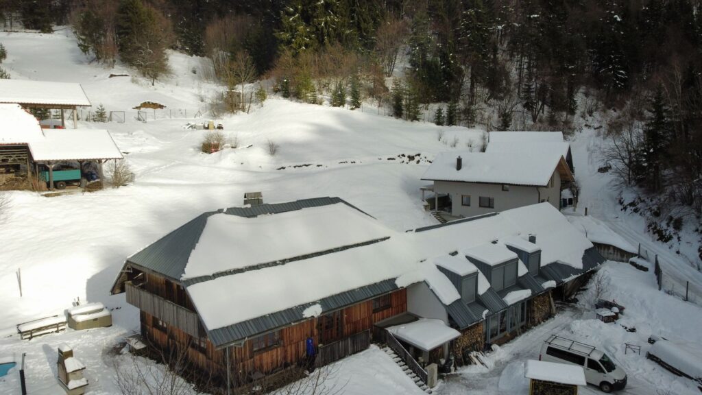 Forest Farmstay under snow, seen from above