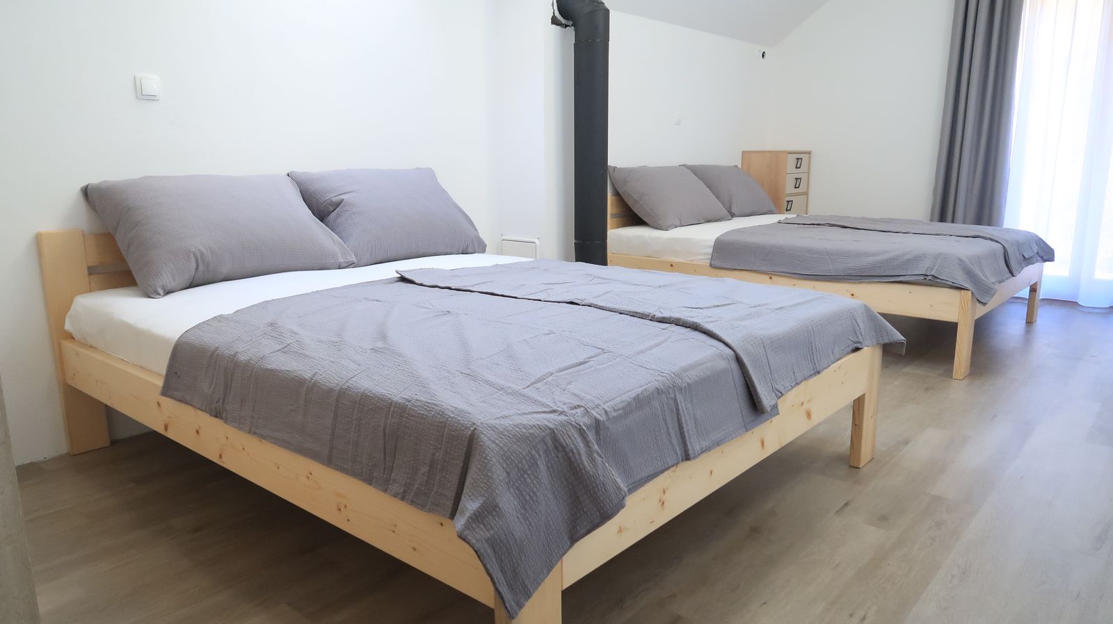 Bedroom with two double beds in the four-bedroom apartment